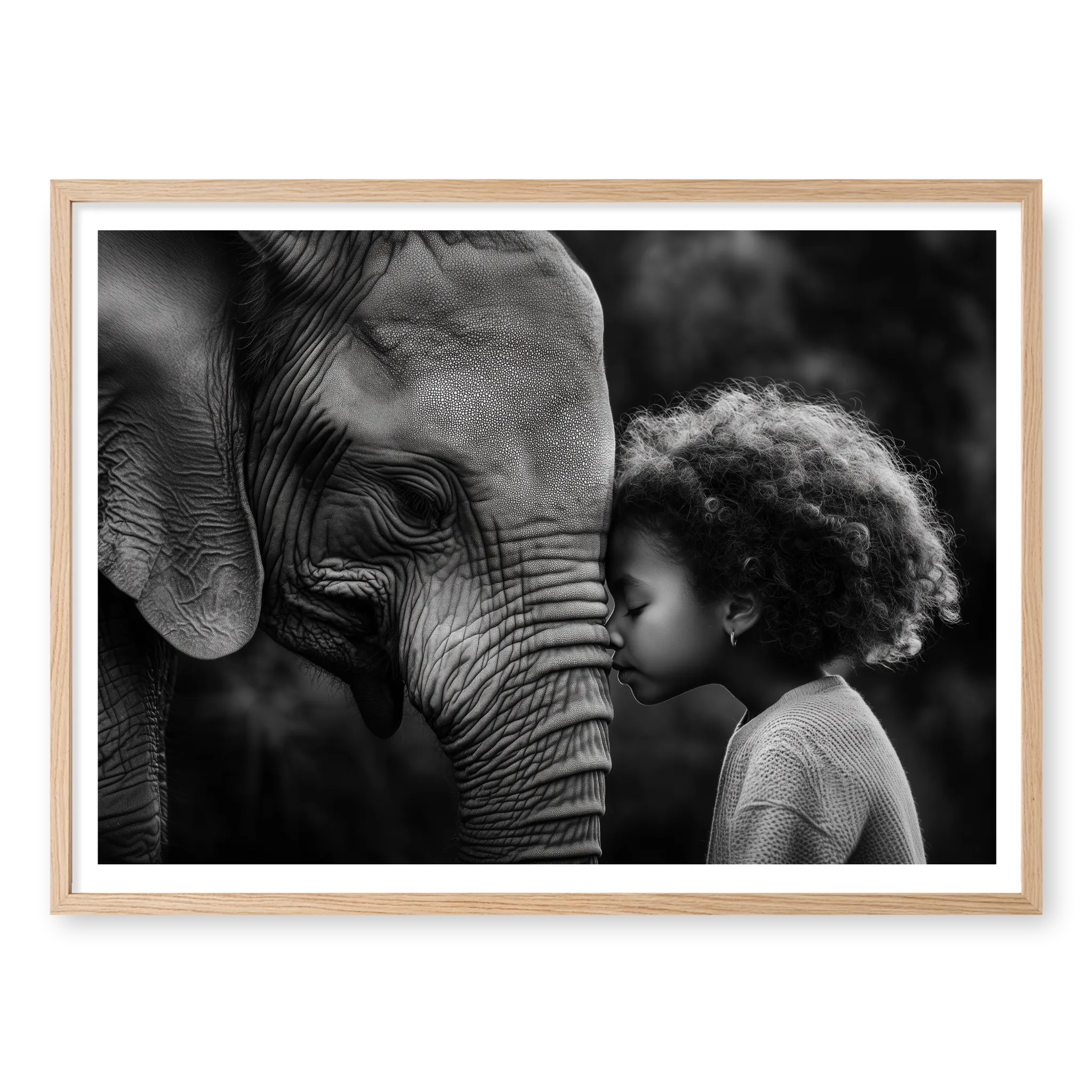 Close-up profile of an elephant and a young girl with curly hair touching foreheads, black and white art print titled A Sacred Moment in natural oak frame