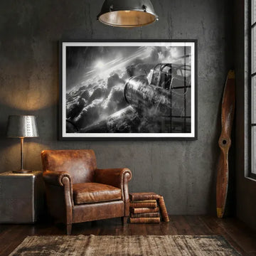 Black and white vintage aircraft artwork displayed in a dark room with leather chair.