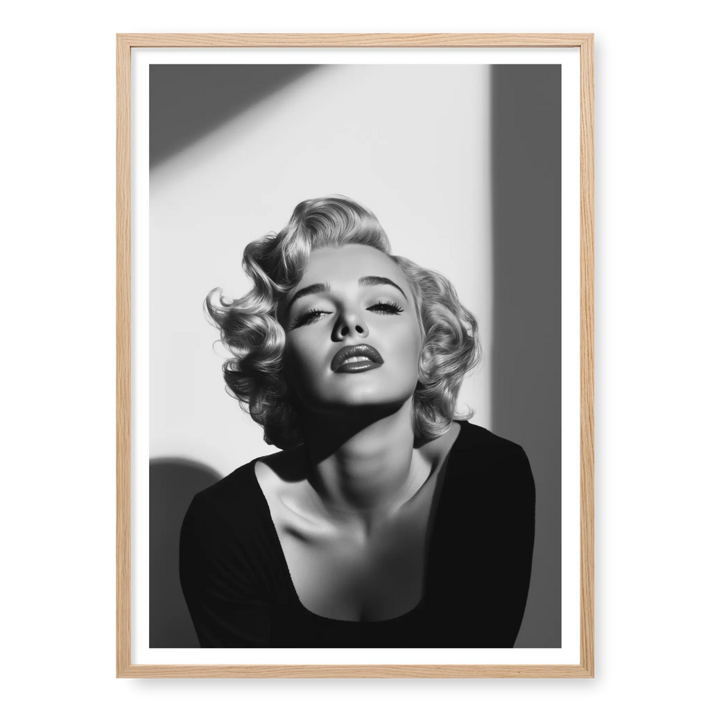 Close-up of Marilyn Monroe with short curly hair and dark lipstick looking up into light, black and white art print titled Blonde Bombshell in natural oak frame