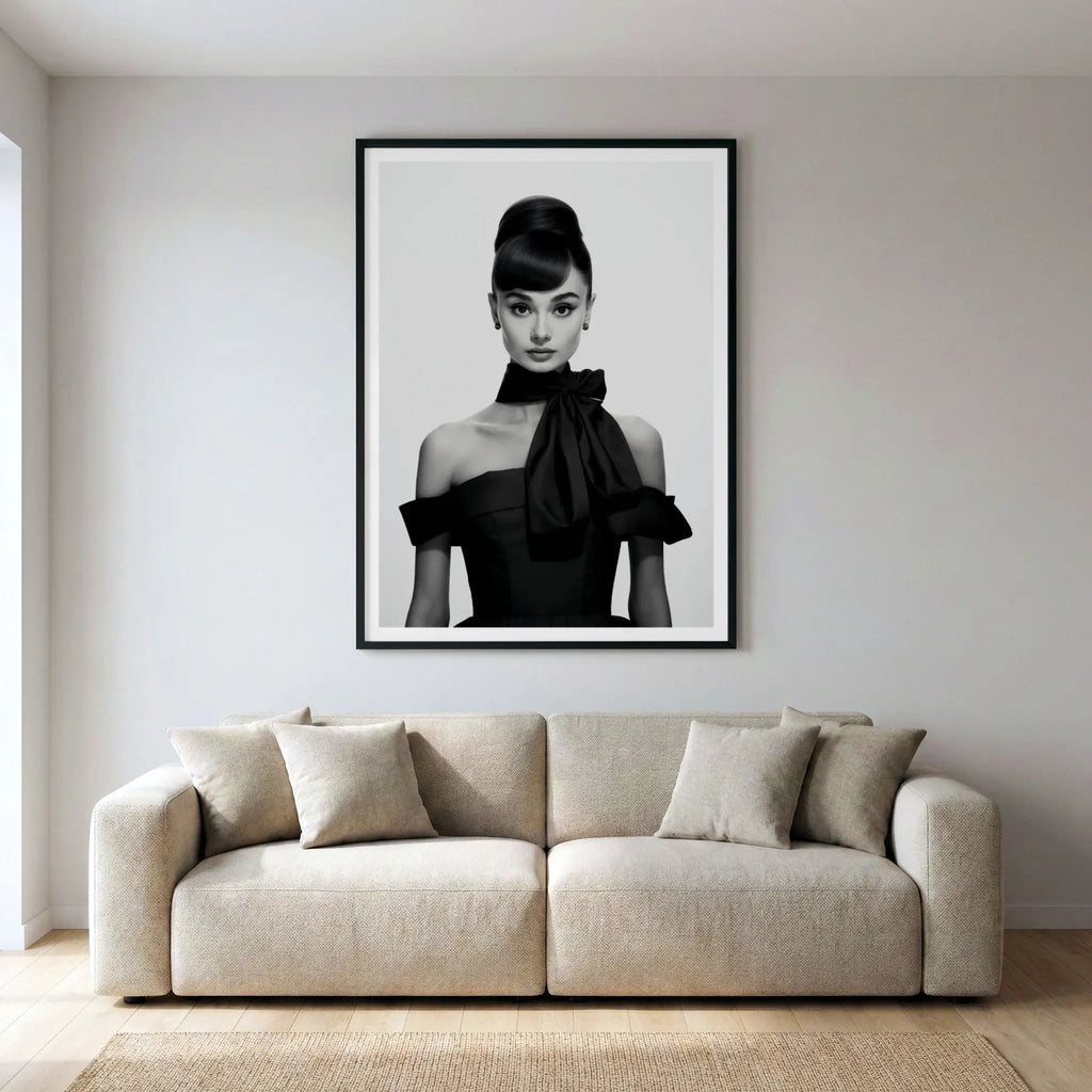 Framed black and white art print of Audrey Hepburn in black dress, titled Breakfast at Tiffany's displayed in living room