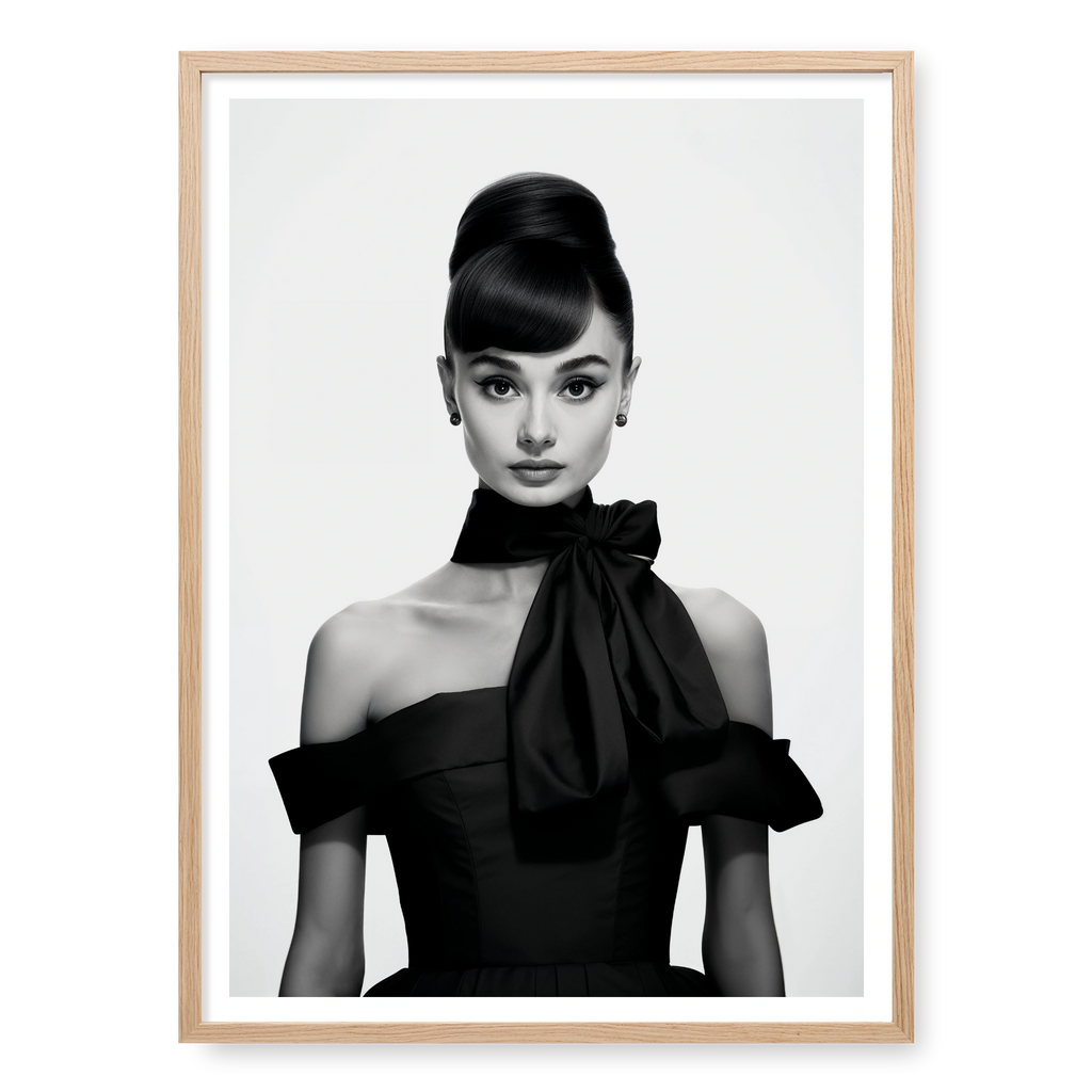 Portrait of Audrey Hepburn with high bun and black bow dress, black and white art print titled Breakfast at Tiffany's in natural oak frame