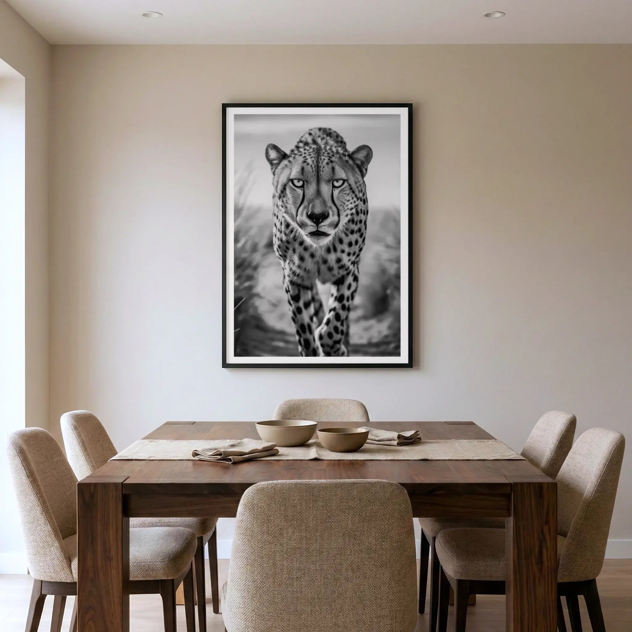 Framed black and white art print with cheetah walking forward, titled Celeritas displayed in dining room