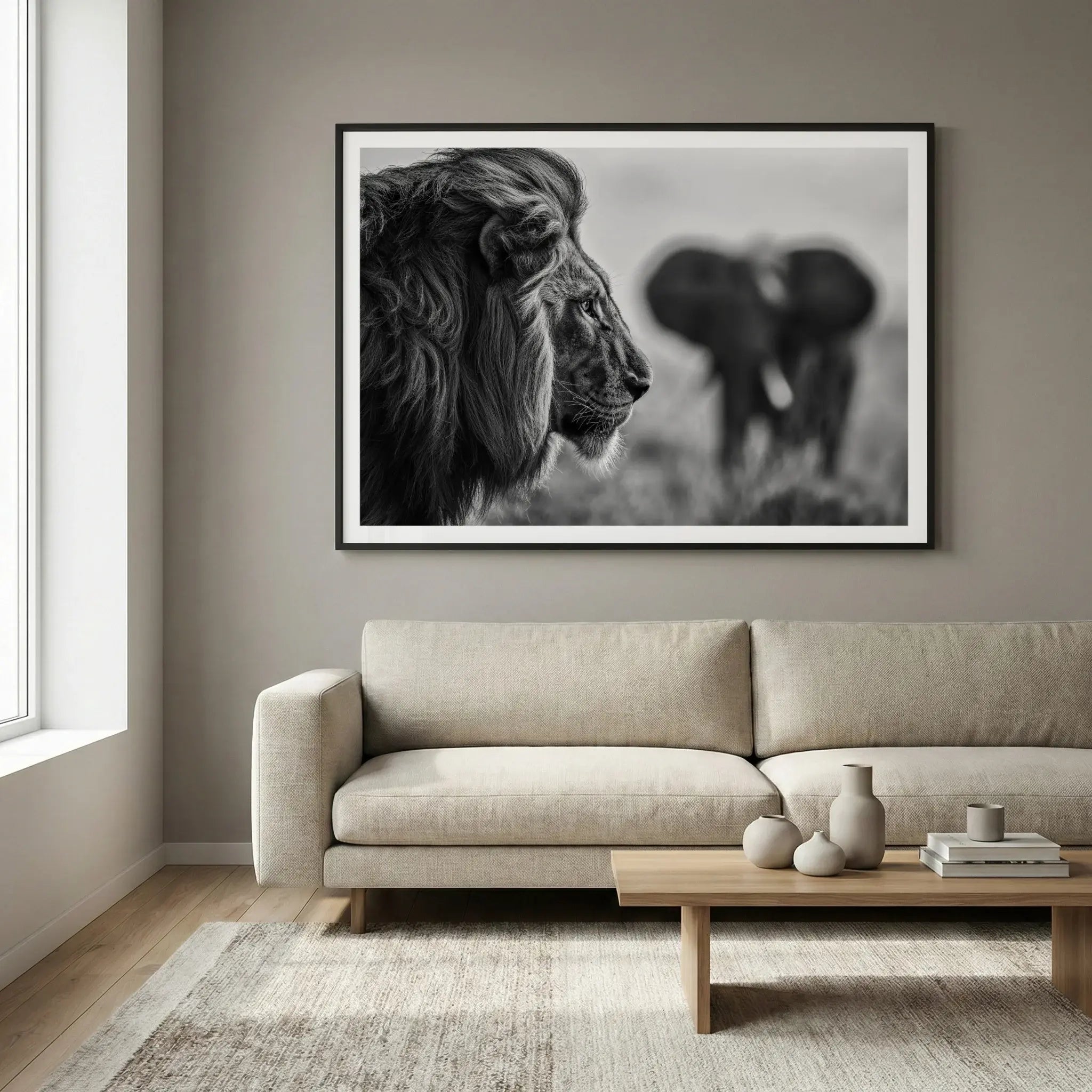 Framed black and white art print with lion profile and elephant background, titled Intellectus displayed in living room