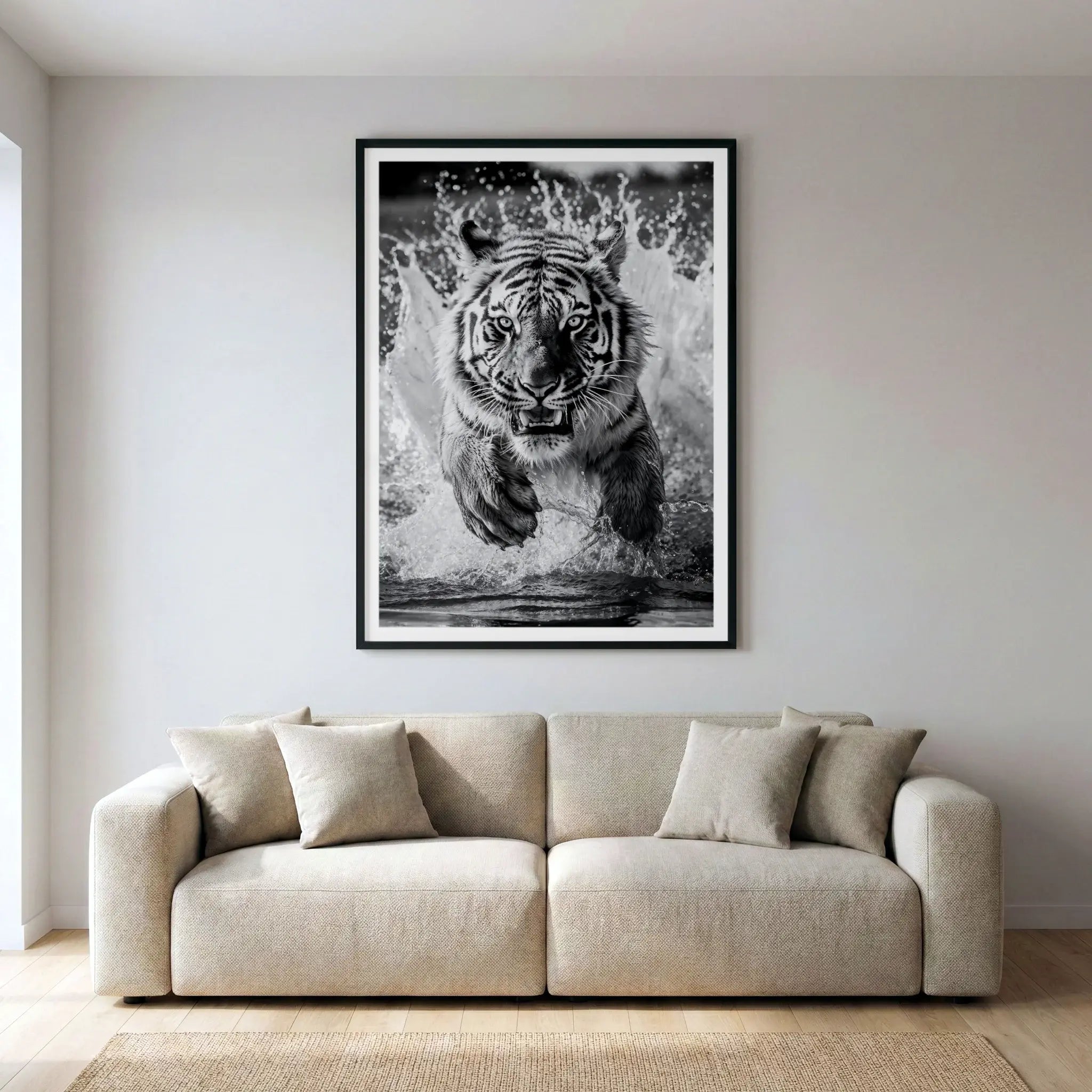 Framed black and white art print with tiger running through water, titled Kahn displayed in living room