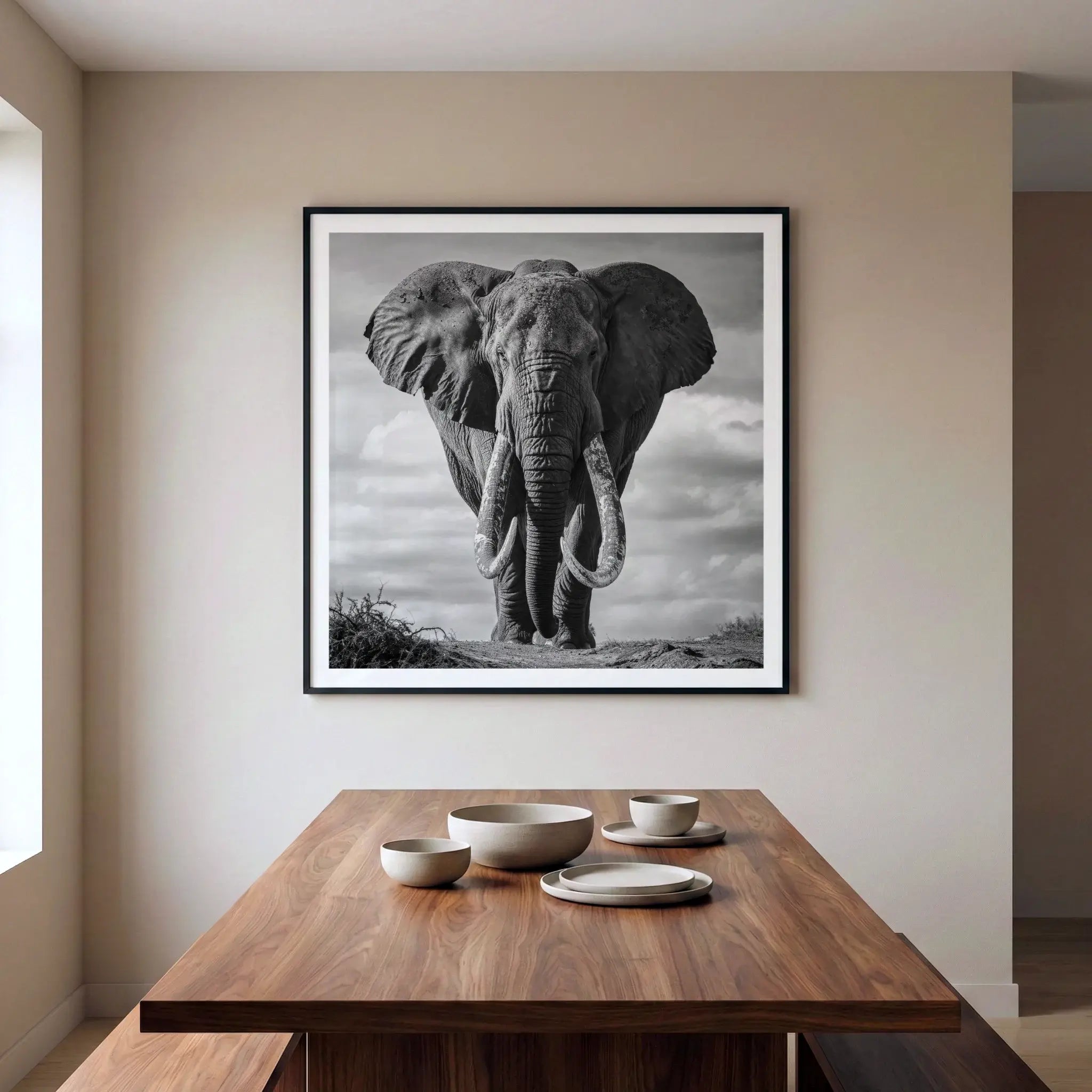 Framed black and white art print with giant elephant tusker, titled Kratos displayed in dining room