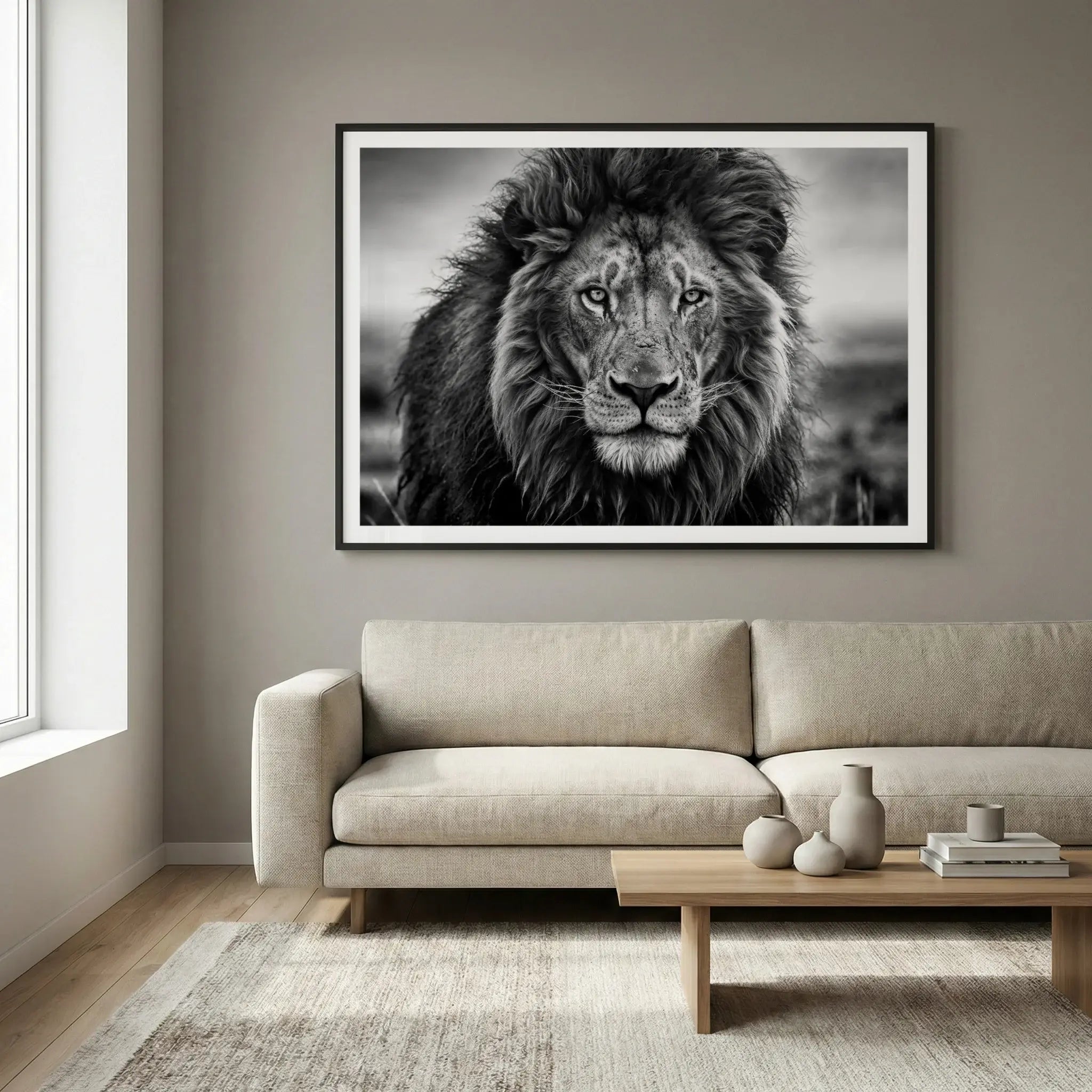 Framed black and white lion portrait with intense gaze, titled Leo displayed in living room