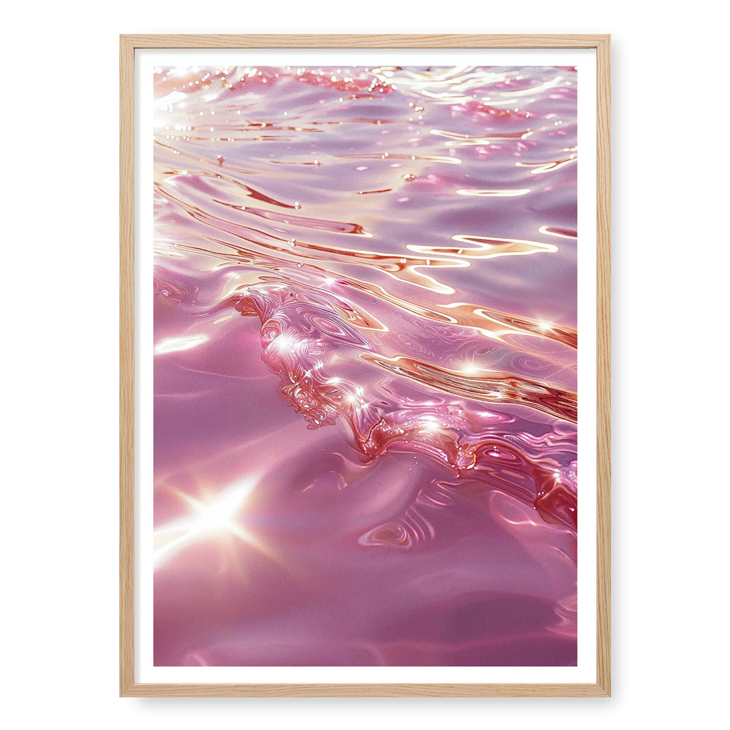 Close-up abstract view of rippling ocean water in shades of pink and rose gold with bright sun glints, art print titled Marmoris in natural oak frame
