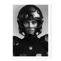 Close-up front-facing portrait of a female American football player wearing a glossy black helmet and pads with the NFL logo, black and white art print titled Modern Gladiator