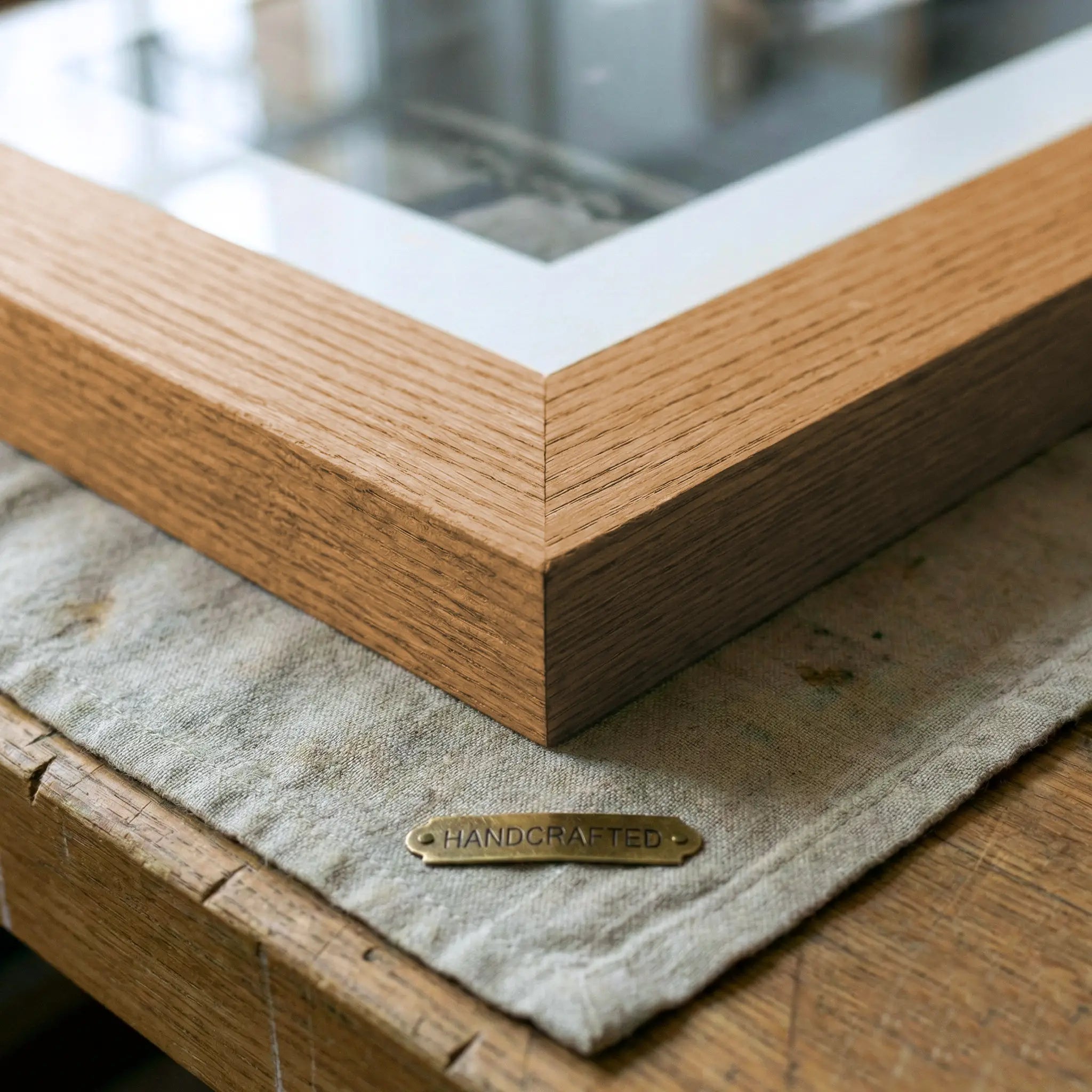 Close-up of handcrafted oak picture frame corner with natural wood grain