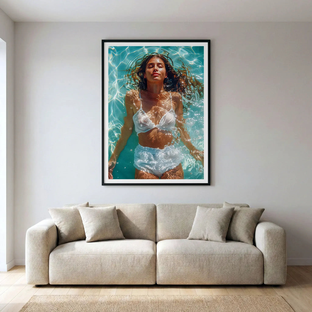 Framed summer art print with woman floating in a pool, titled Paradise displayed in living room
