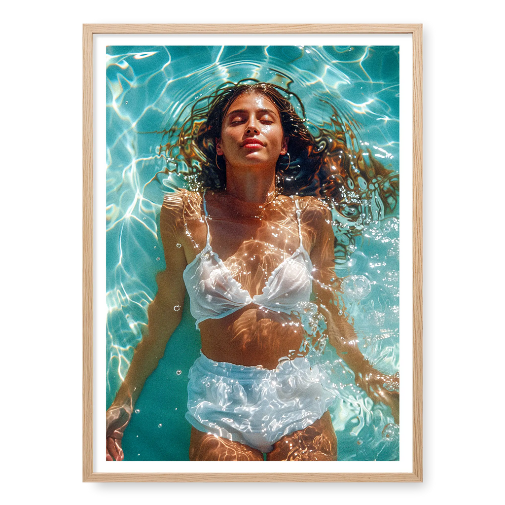Top-down view of a woman in white swimwear floating peacefully in bright blue pool water with sun ripples, art print titled Paradise in natural oak frame