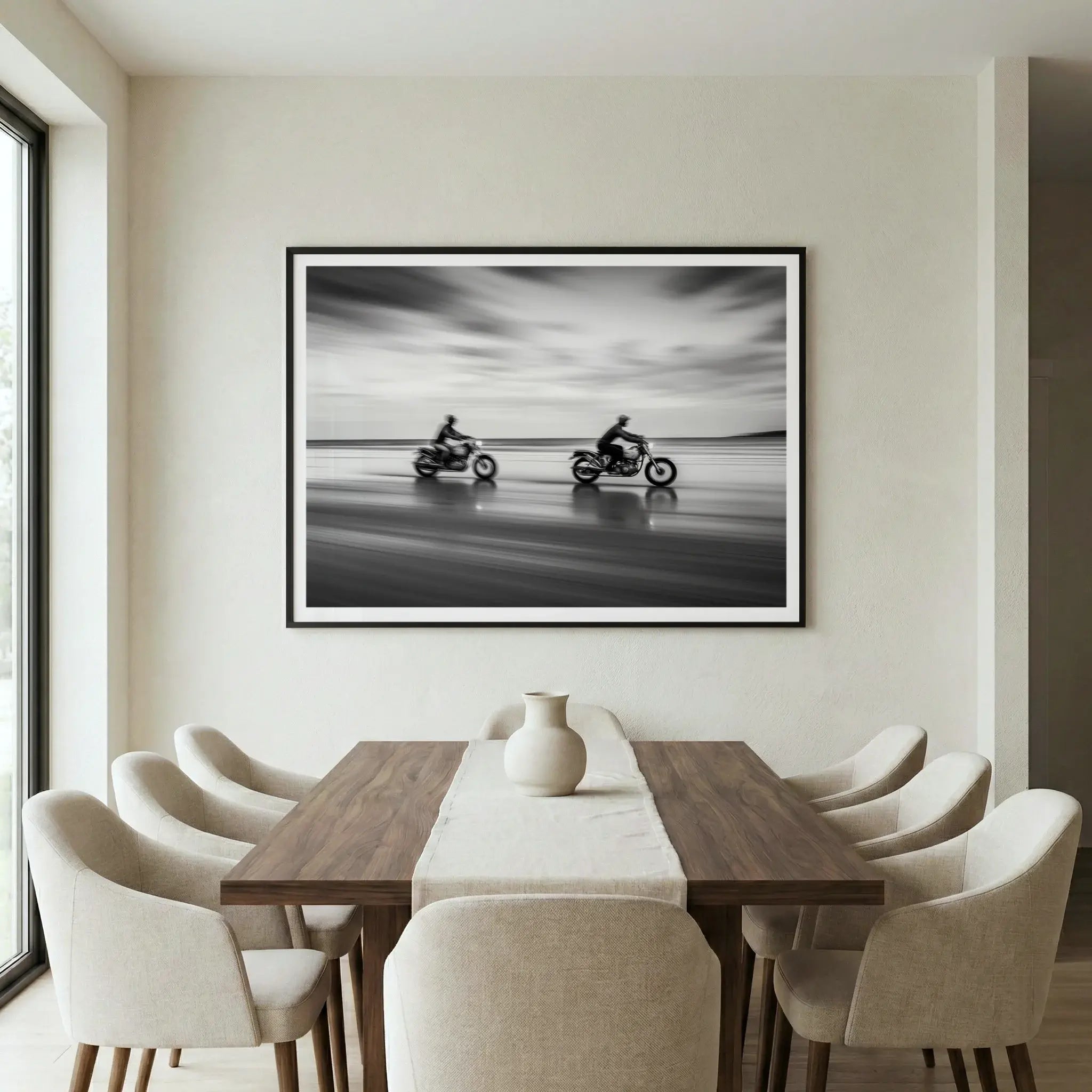 Framed black and white motorcycle art print with motion blur, titled Partners displayed in dining room