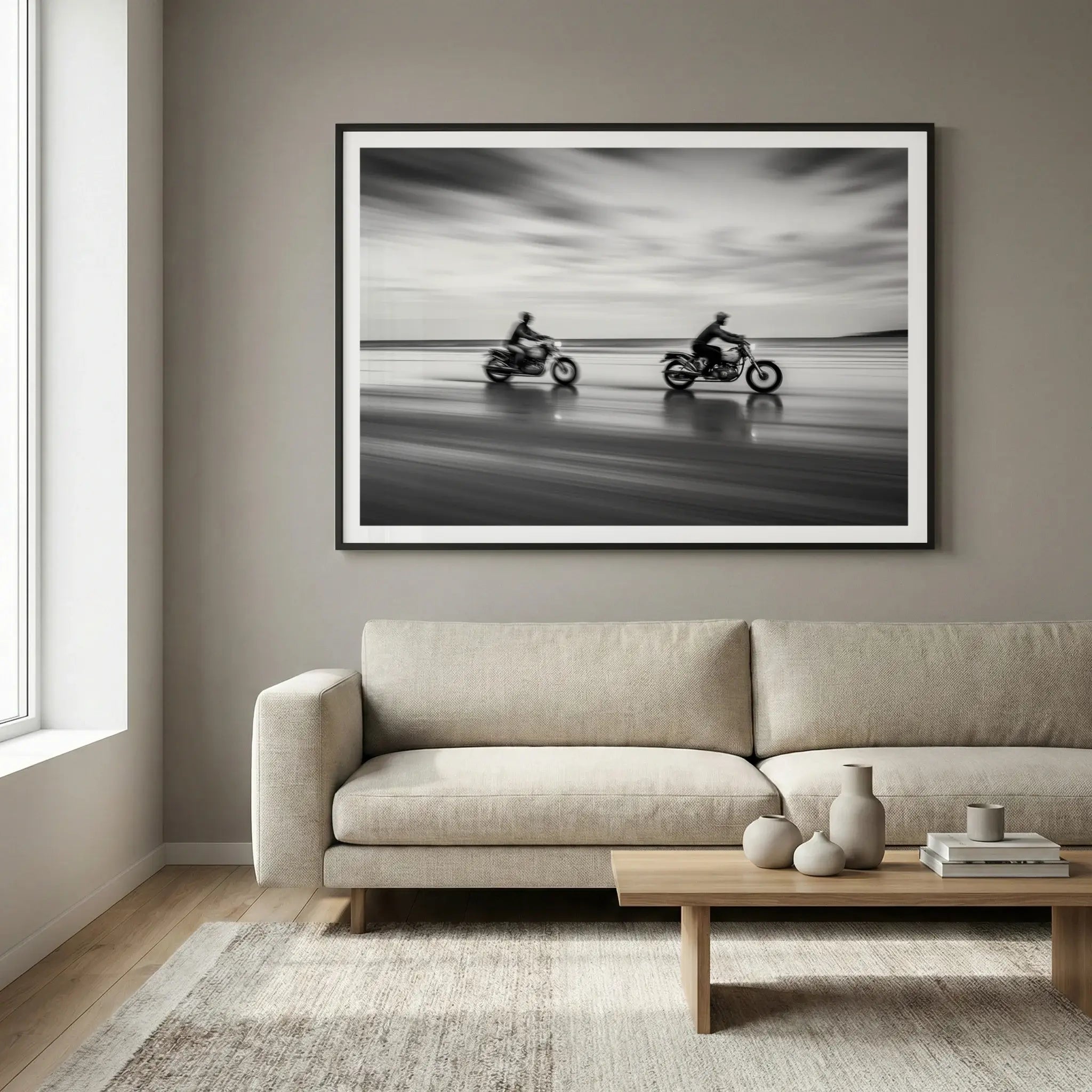 Framed black and white motorcycle art print with motion blur, titled Partners displayed in living room