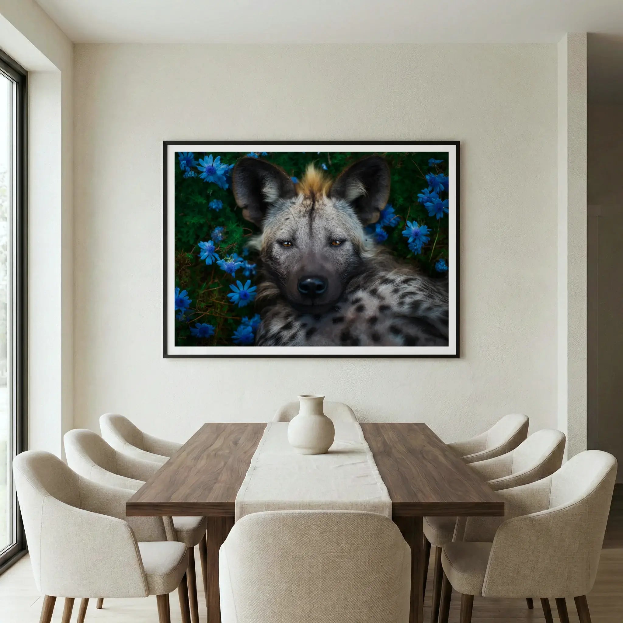 Framed wildlife art print with hyena and blue flowers, titled Peace displayed in dining room