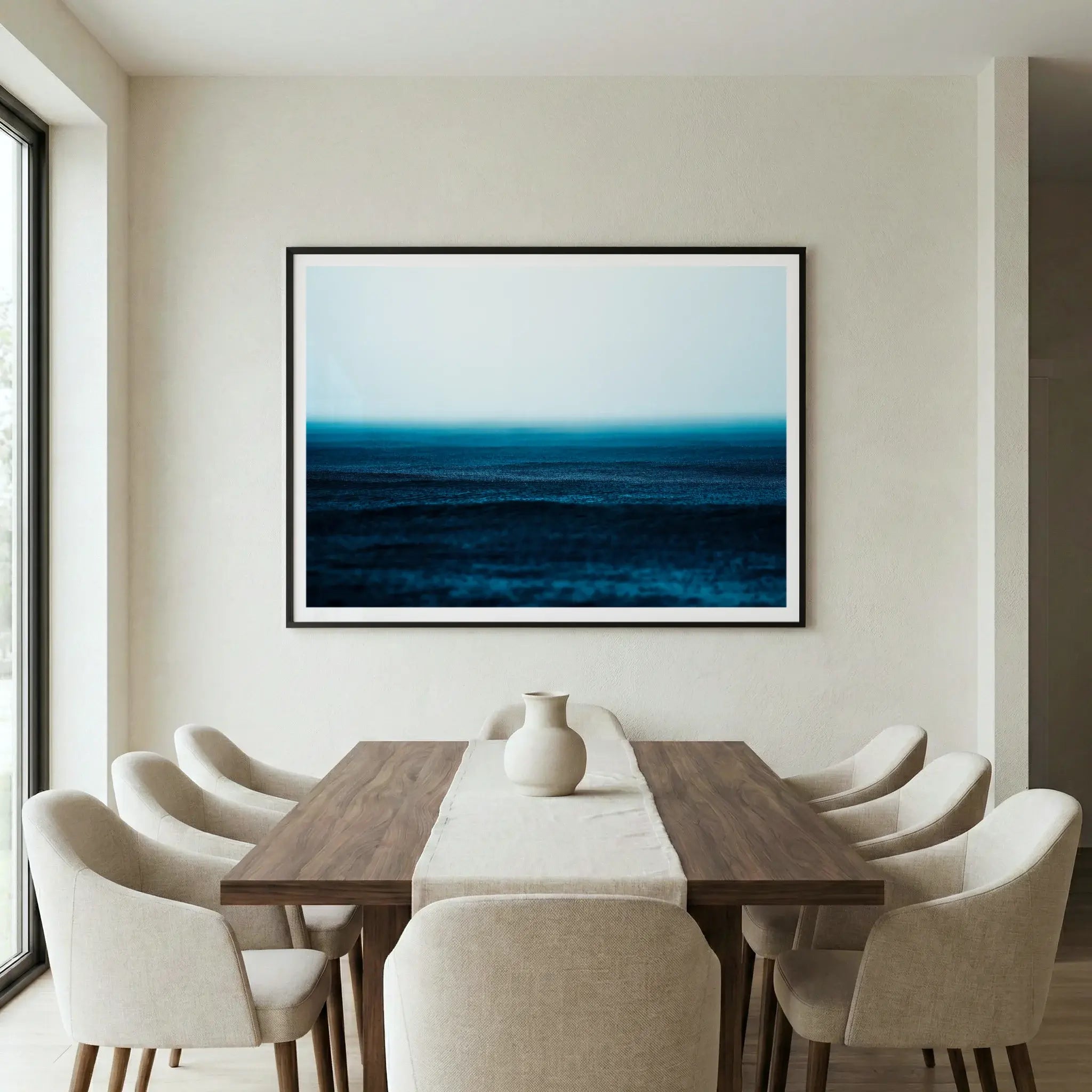 Framed moody ocean art print with rain texture and mist, titled Petrichor displayed in dining room