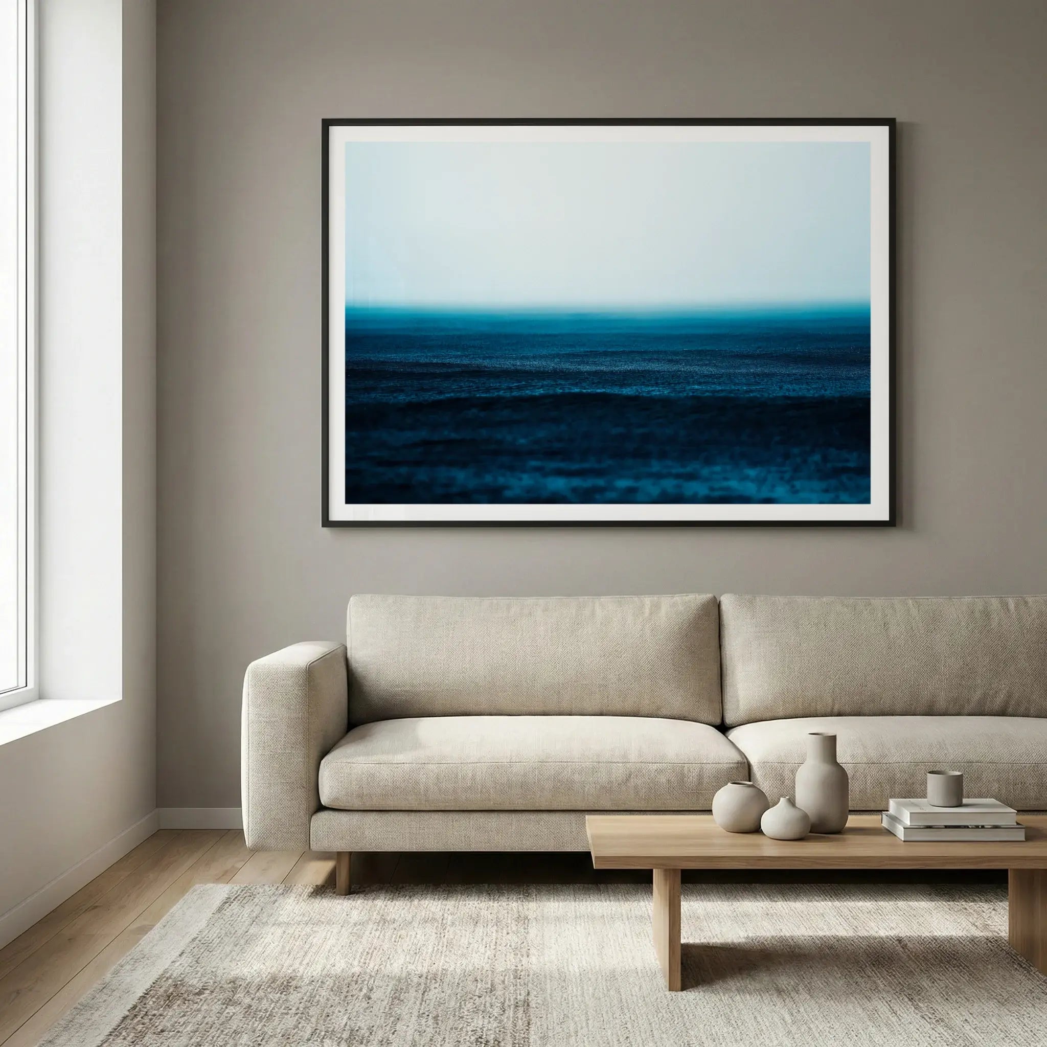 Framed moody ocean art print with rain texture and mist, titled Petrichor displayed in living room