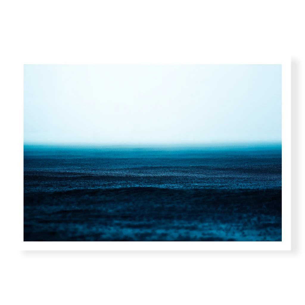 Minimalist seascape with deep blue water textured by falling rain fading into a misty white horizon, art print titled Petrichor