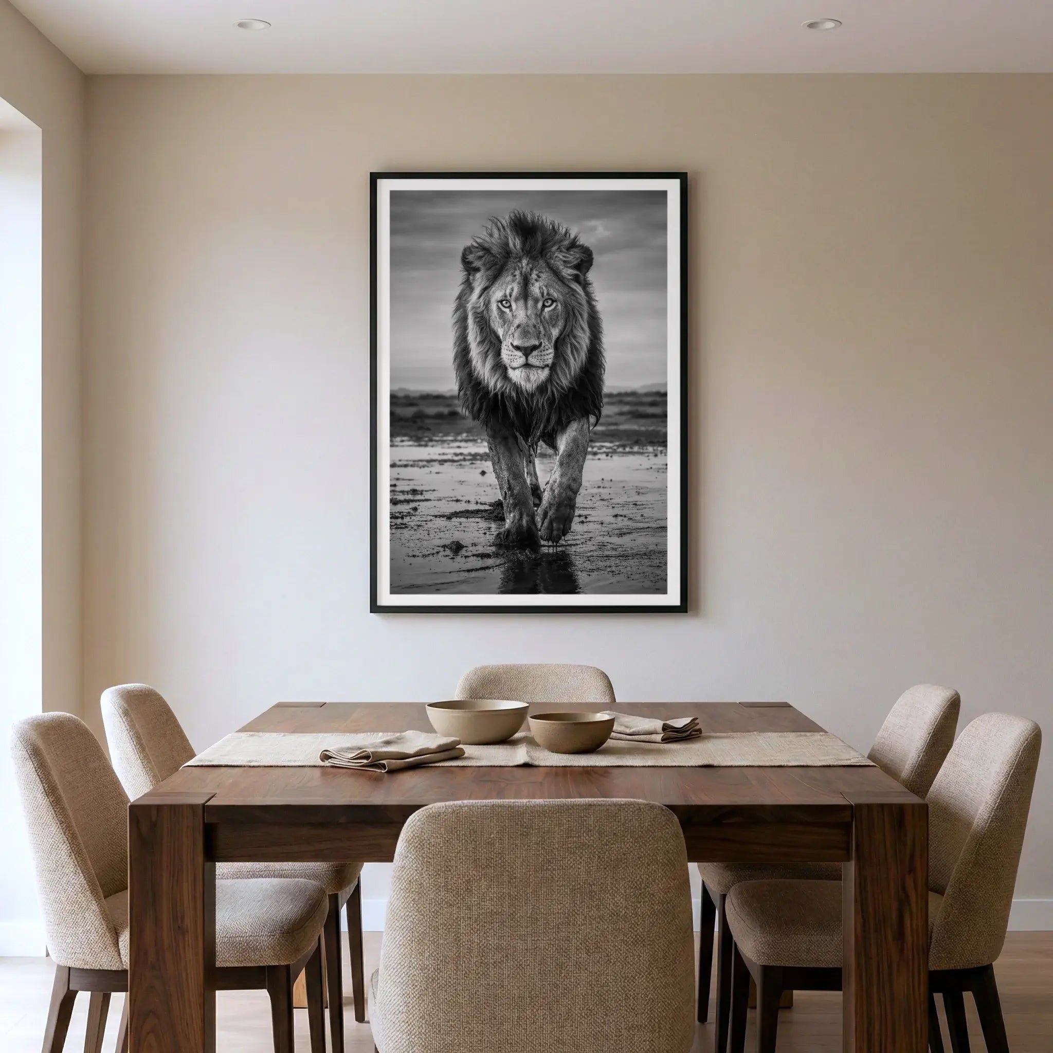 Framed black and white art print with lion walking on savannah, titled Pride displayed in dining room