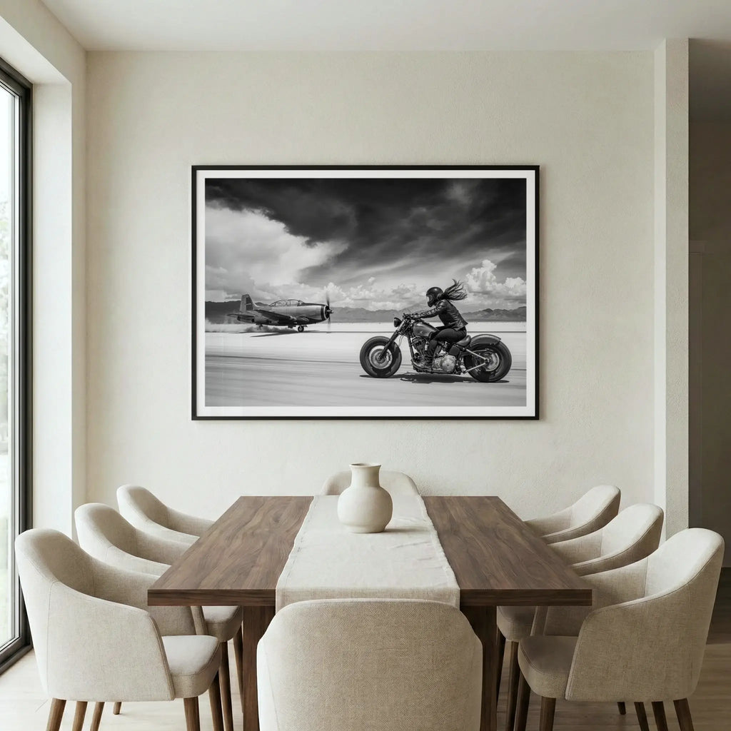 Framed automotive art print with motorcycle racing a plane, titled Ride or Die displayed in dining room