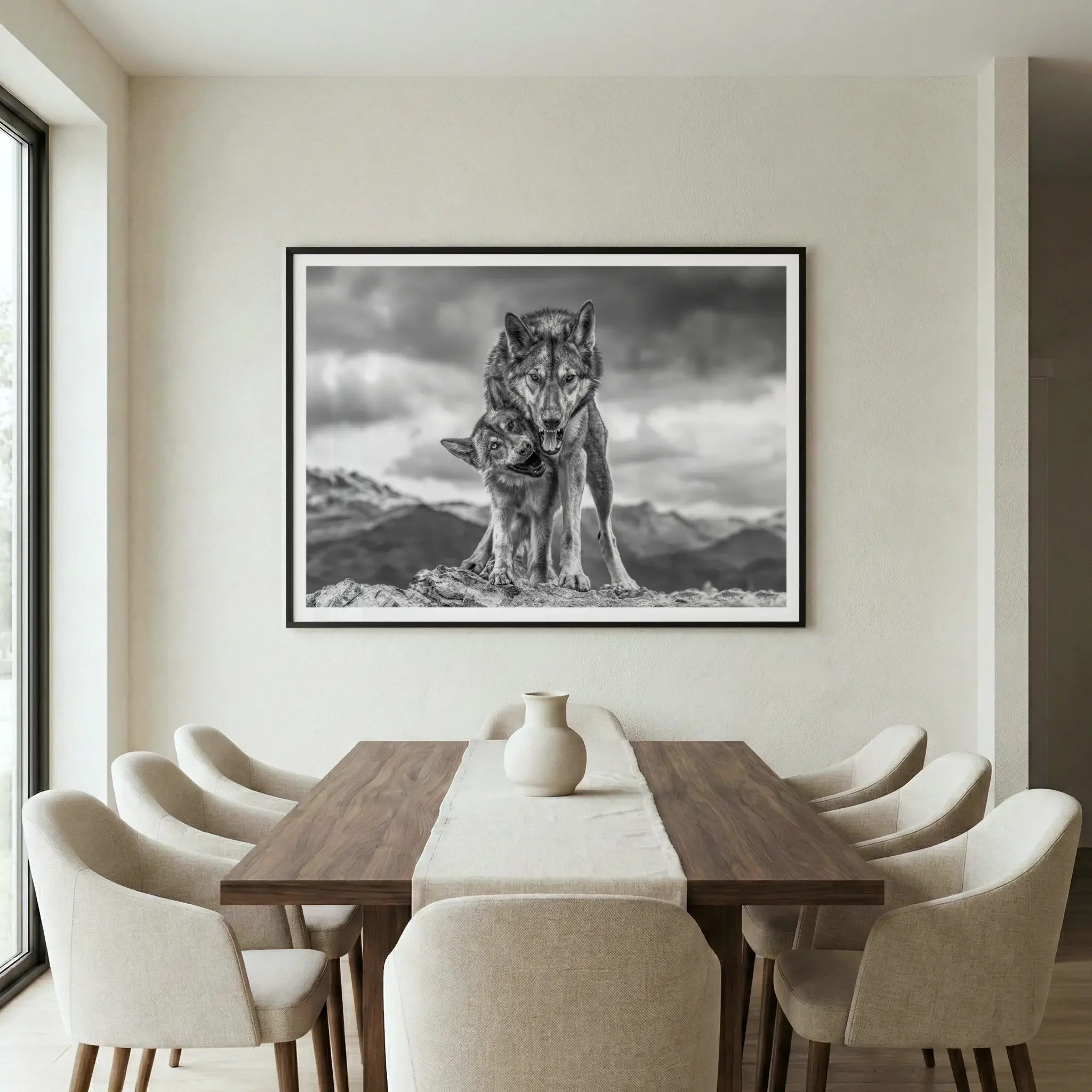Framed wildlife art print with wolves on a mountain, titled Safe displayed in dining room