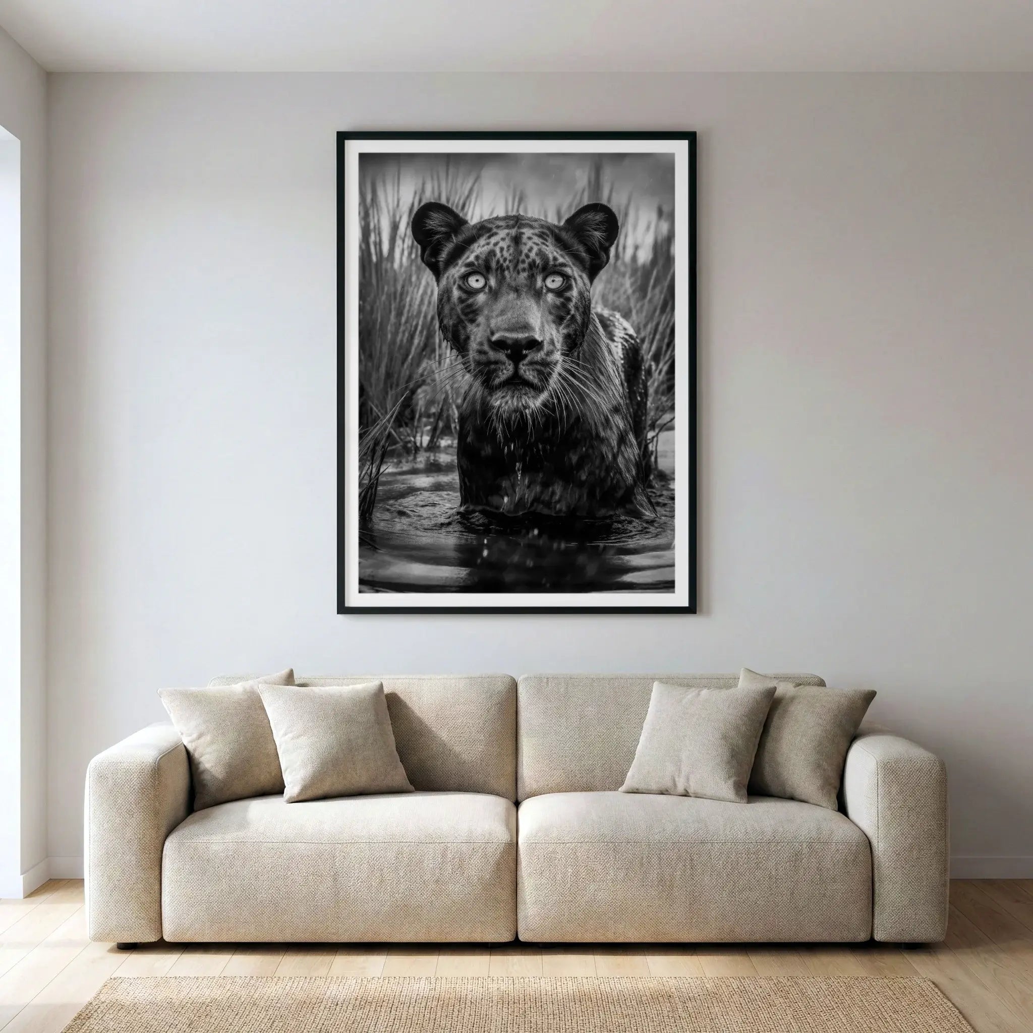 Framed black and white wildlife art print with panther wading in water, titled Shuri displayed in living room