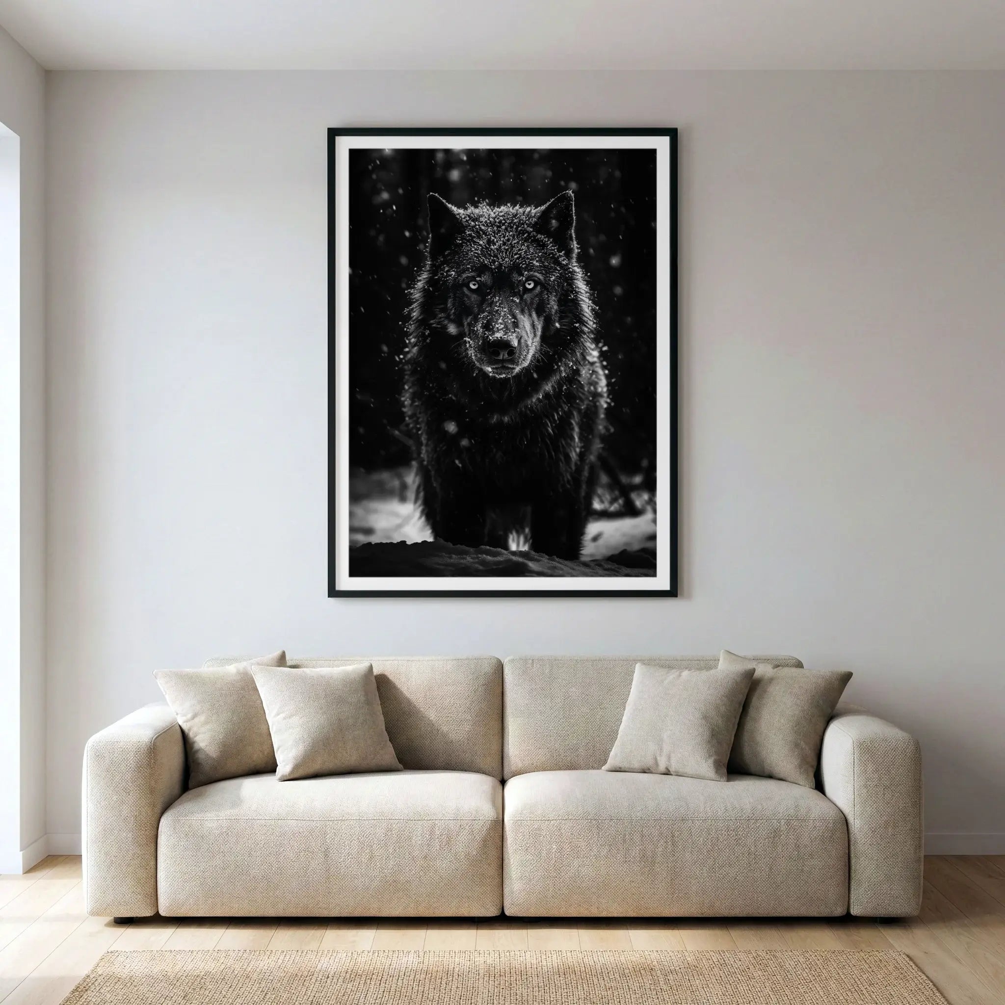 Framed black and white wildlife art print with black wolf in snow, titled Solitarius Lupus displayed in living room