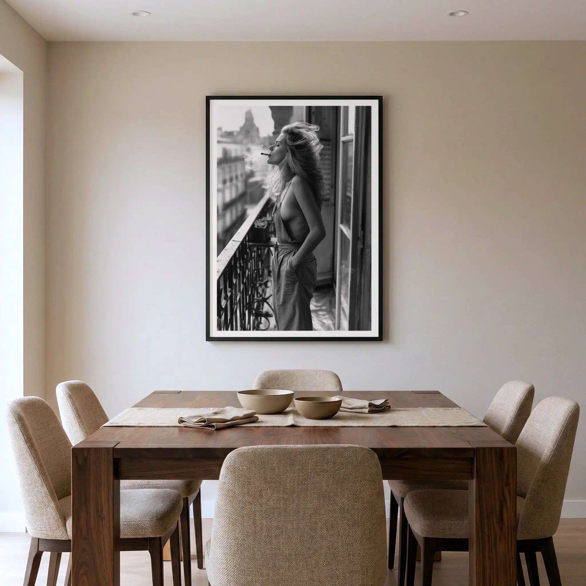 Framed black and white lifestyle art print with woman on balcony, titled Sonder displayed in dining room