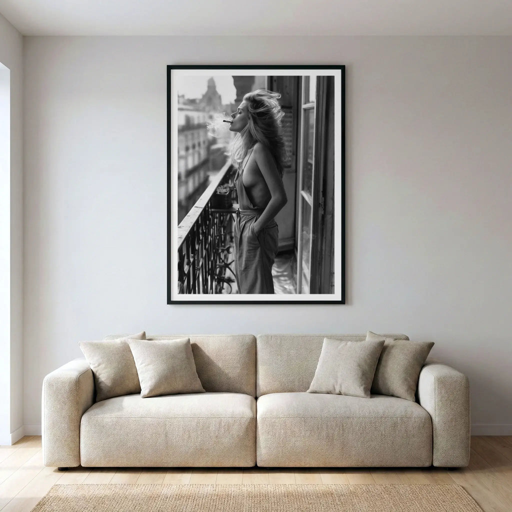 Framed black and white lifestyle art print with woman on balcony, titled Sonder displayed in living room
