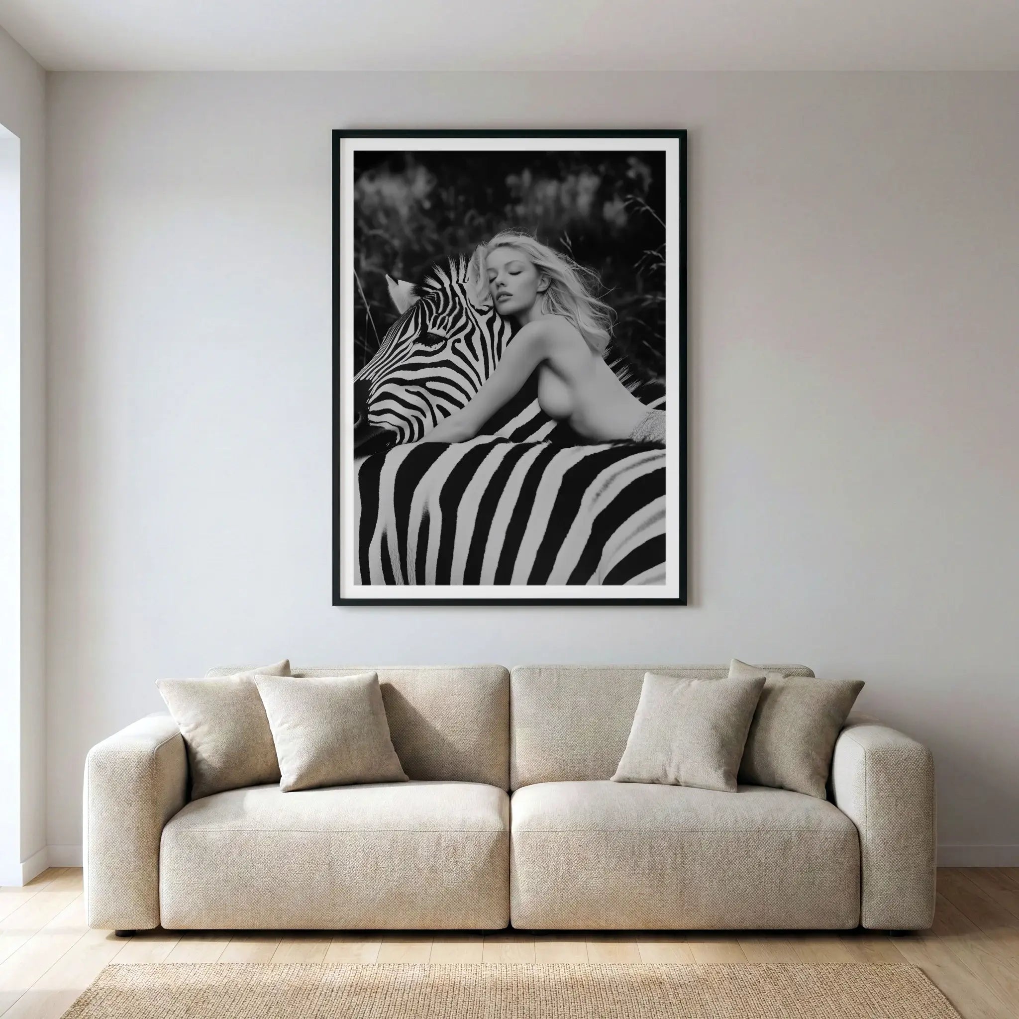 Framed black and white fine art print with woman and zebra, titled Stripes displayed in living room