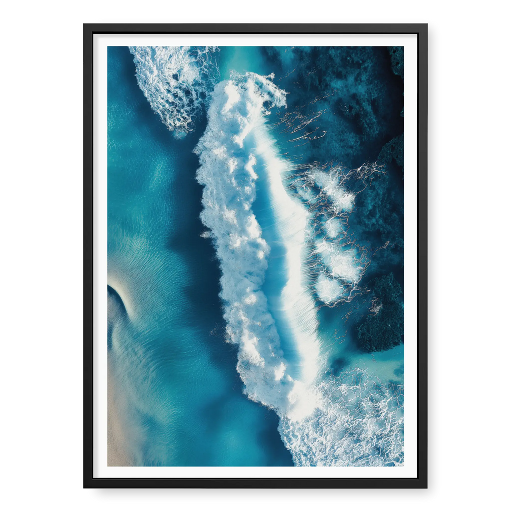 Aerial top-down view of a large white wave crashing in deep blue and turquoise ocean water with visible foam texture, art print titled Terra Mater in black frame