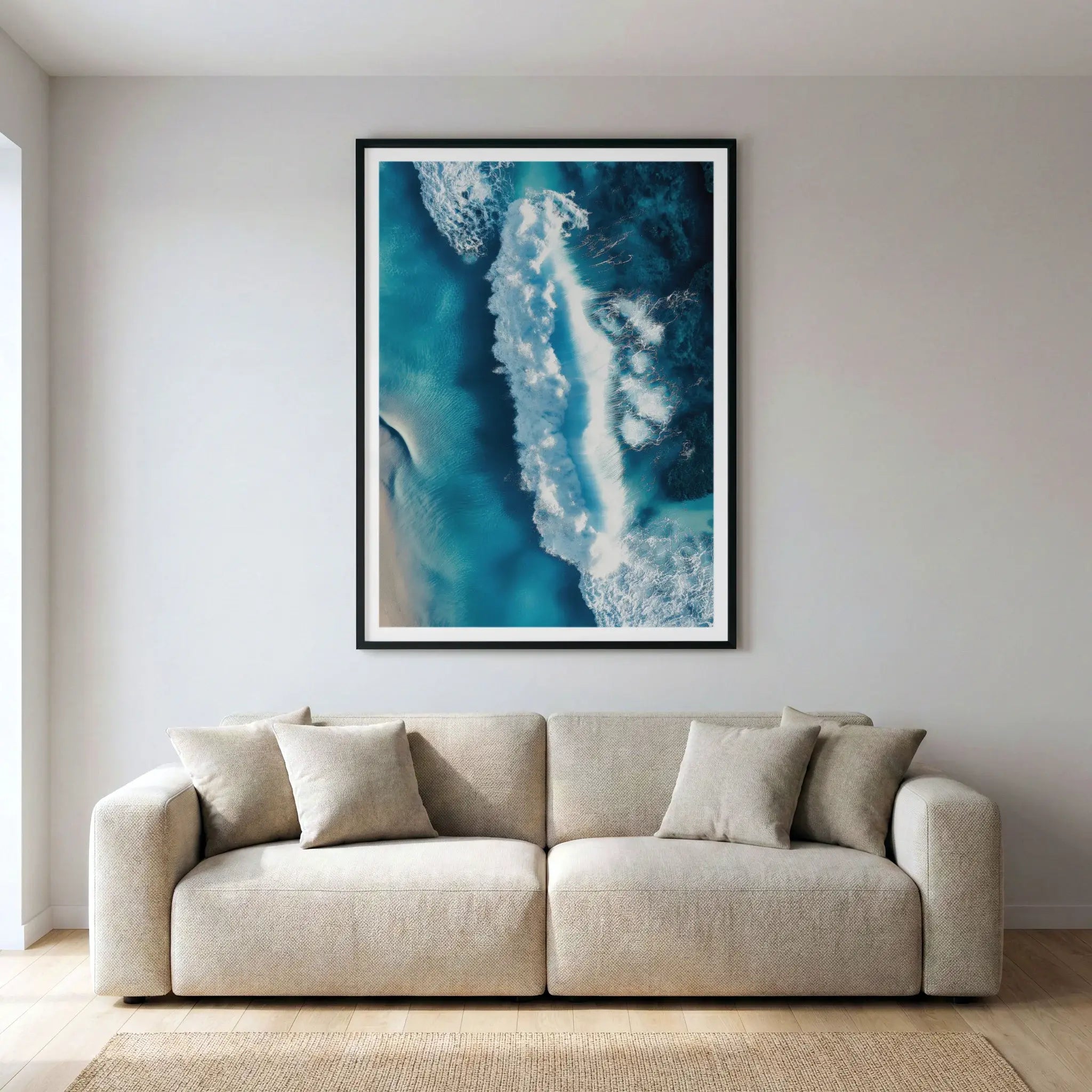 Framed aerial ocean art print with crashing wave, titled Terra Mater displayed in living room