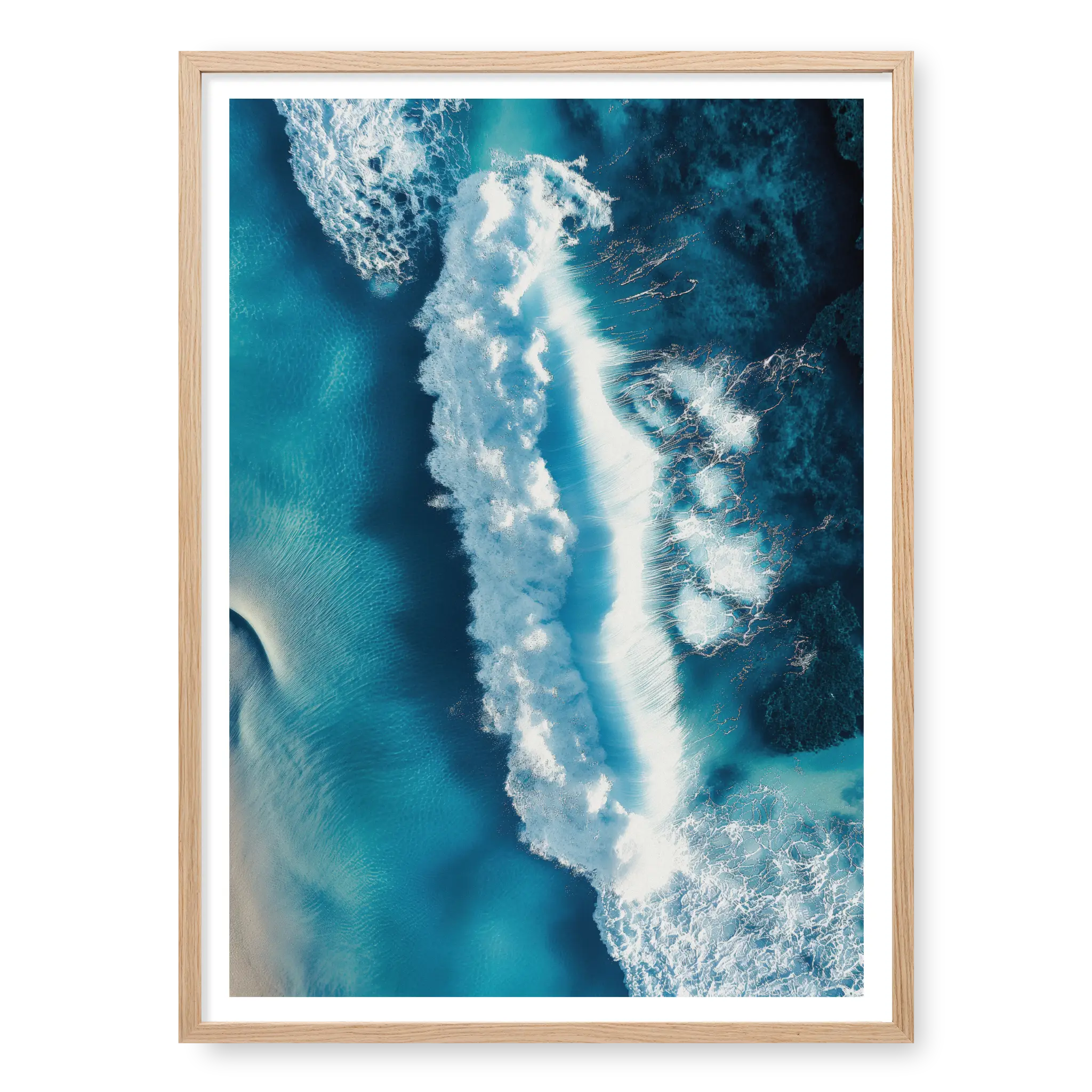 Aerial top-down view of a large white wave crashing in deep blue and turquoise ocean water with visible foam texture, art print titled Terra Mater in natural oak frame