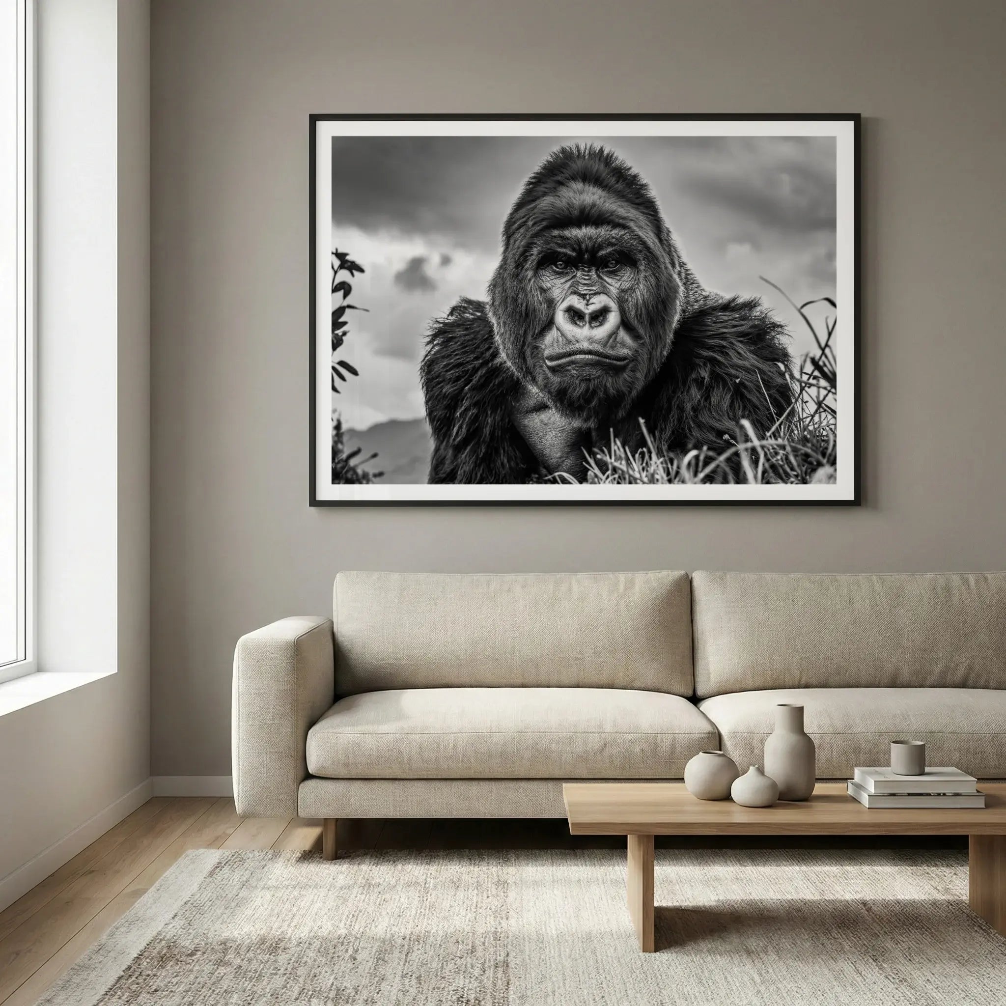 Framed black and white wildlife art print with gorilla portrait, titled The King displayed in living room